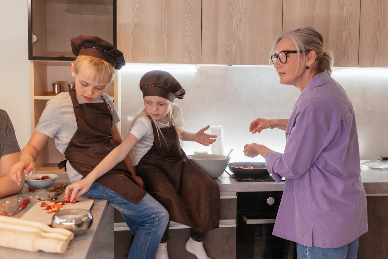 about-us Elderly woman and children cooking together, fostering family bonding.